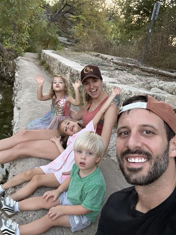 Adam Styer with his family on an outdoor trail